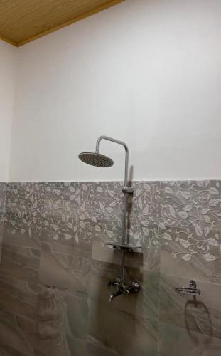 a bathroom with a sink and a light on a wall at Jeevaka Villa & Ayurveda Retreat in Galle