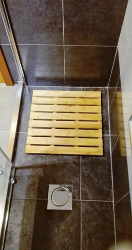 a shower with a wooden bench on the floor at Mericia's Gorgeous View in Funchal