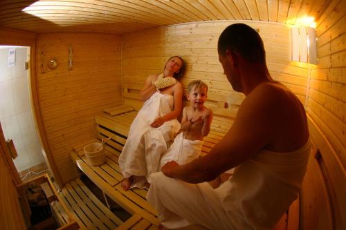 two women and a little girl in a sauna at Hotel Srní a Depandance in Srní