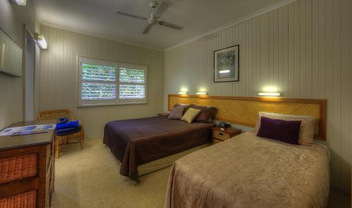 a hotel room with two beds and a window at Somerset Apartments in Lord Howe