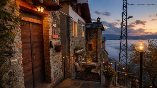 a balcony of a building with a table and a view at Rustico Verginate in Bellano