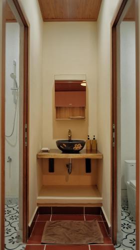 a bathroom with a sink and a toilet at Yên Retreat & Cafe in Cà Mau