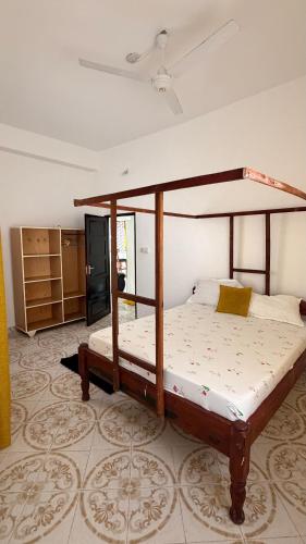a bedroom with a canopy bed in a room at the velvet nest in Watamu