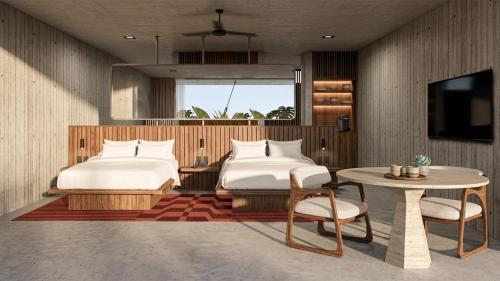 a bedroom with two beds and a table and a tv at NANANA Hotel de Mar - Solo Adultos in Puerto Escondido