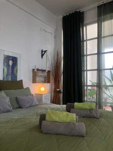 a bedroom with a large bed with two pillows on it at Oneiro glico in Agia Marina Aegina