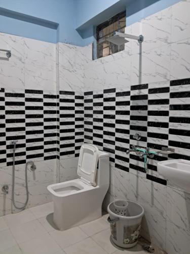 a bathroom with a toilet and a sink at Krishna palace in Pīpalkoti