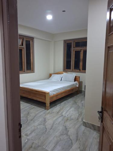 a bedroom with a bed in a room at Demazong Homestay in Ravangla