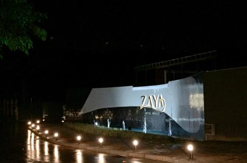 a building with a sign on the side of it at night at Zaya Motel Premium in Florianópolis