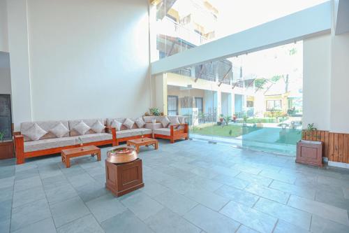 a living room with couches and tables in a building at Royal Jungle Villas in Sauraha