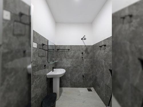 a bathroom with a white sink and a shower at Galpothuyaya Eco Lodge Kandalama in Dambulla