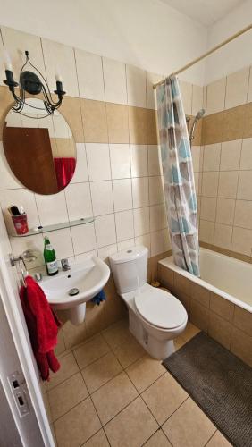 a bathroom with a toilet and a sink and a tub at Villa Caesar in Ayia Napa