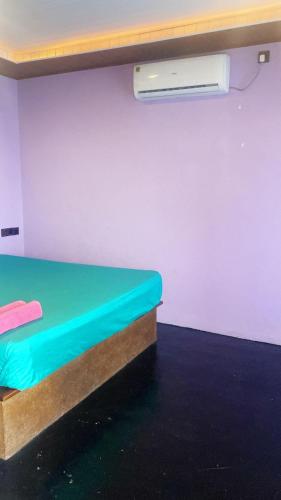 a room with a bed and a heater on a wall at Anya's Loft - Sky Stay in Mirissa