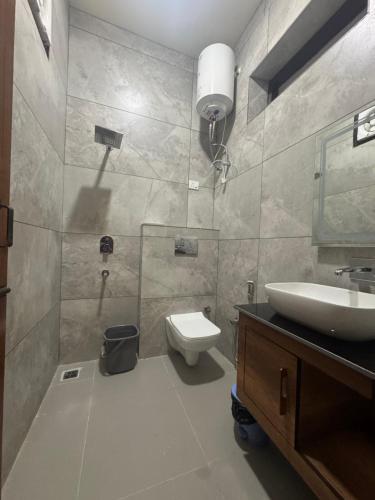 a bathroom with a sink and a toilet at Skyview Stays I Party Lawns I Adjacent The Good Club I 1km Sukhna lake,Rock Garden & High Court I in Chandīgarh