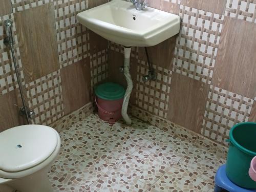 a bathroom with a sink and a toilet at Aziz Guest House Near dal lake in Srinagar