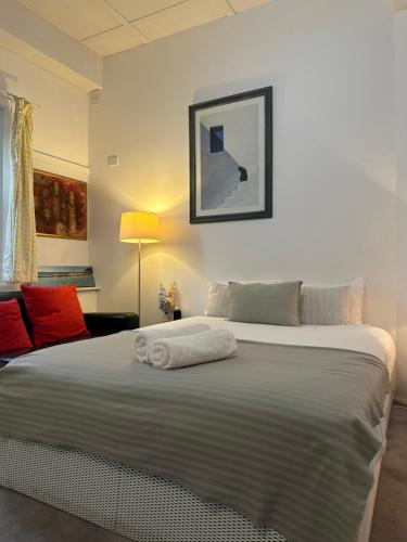 a bedroom with a large bed with towels on it at Manly Beach Studio in Sydney