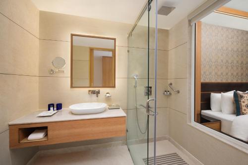 a bathroom with a sink and a shower at Fortune Park Moksha, Mcleodganj - Member ITC Hotels' Group in McLeod Ganj