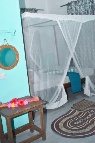 a room with a table and a tent at Bamboo Garden B&B in Kendwa