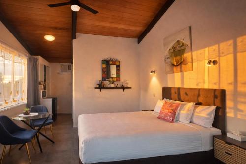 a bedroom with a bed and a table and chairs at Jetty Motel The Entrance in The Entrance
