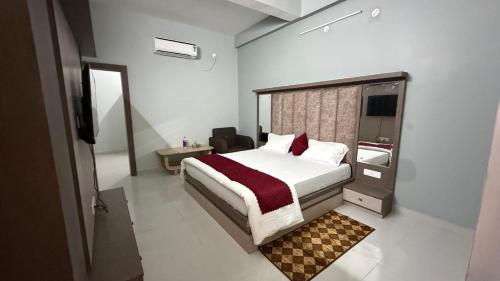 a bedroom with a large bed and a bathroom at S&J Hotel & Banquet in Bhabua