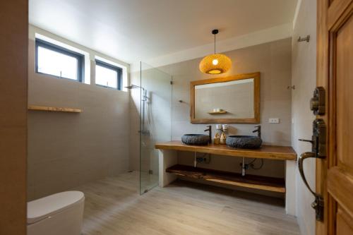 a bathroom with a sink and a mirror at Villa Bodhi in Ko Phangan