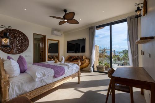 a bedroom with a bed and a view of the ocean at Villa Bodhi in Ko Phangan