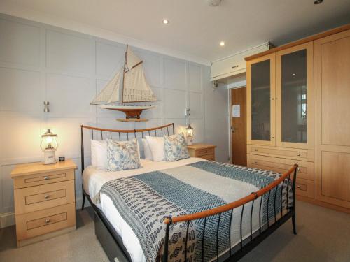 a bedroom with a bed with a sail on it at 24 The Salcombe in Salcombe