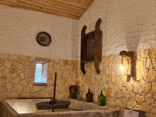 a stone kitchen with a sink and a window at Quinta do Penedo- Refúgio de Charme e Natureza in Ferreira do Zêzere