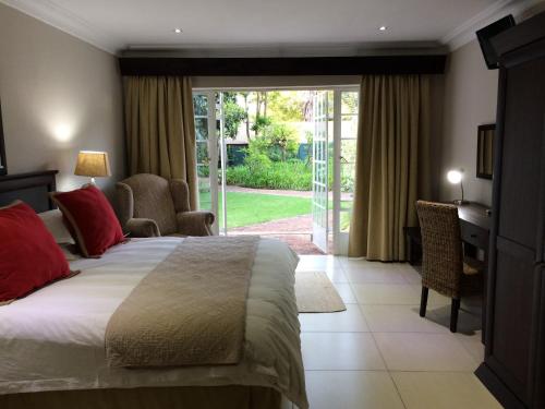 a bedroom with a bed and a sliding glass door at Polokwane Place in Polokwane