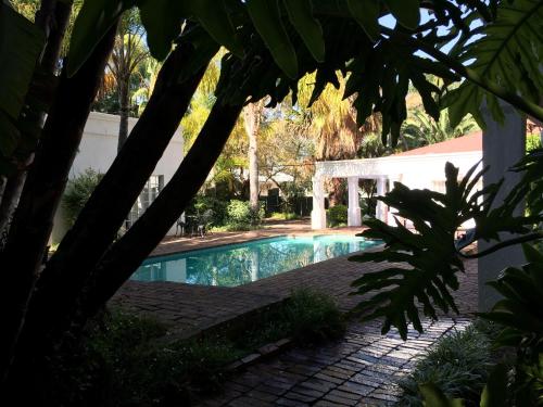 a swimming pool in a yard with a house at Polokwane Place in Polokwane