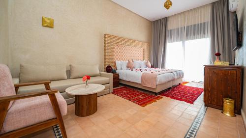 a living room with a bed and a couch at Igrane House - Resort & Spa in Aït Faska