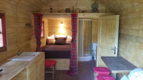 a bedroom with a bed and a sink in a room at Les Arbousiers Village Hôtel Provençal in La Roquebrussanne