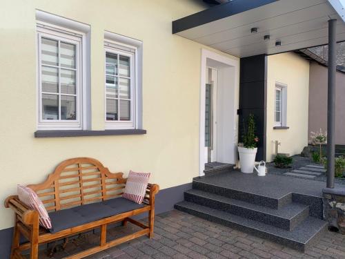 a porch with a bench on a house at Moselglück in Pölich