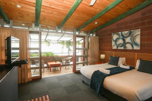 a bedroom with two beds and a balcony at Asali Lodge in East London