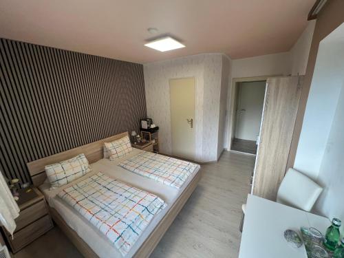 a bedroom with a large bed in a room at Pension Erlerhof Chez Karin in Tulfes
