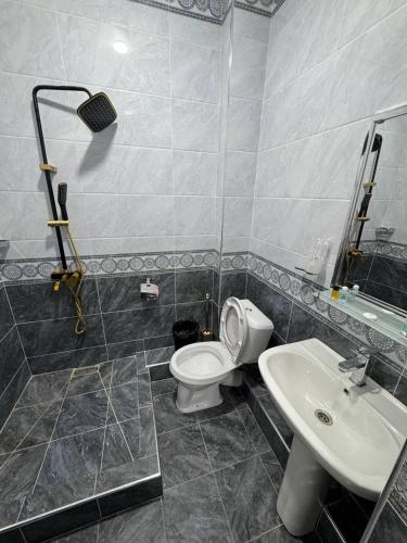 a bathroom with a toilet and a sink at ALAmir Khiva in Khiva