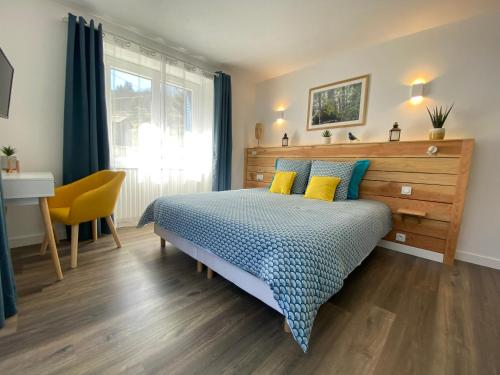 a bedroom with a bed and a desk and a window at Ardeche2coeur in Marcols-les-Eaux
