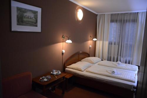 Säng eller sängar i ett rum på Hotel Minerva