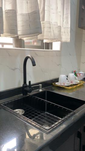 a sink in a kitchen with a sinkyss at Crystal Apartment in Ofada