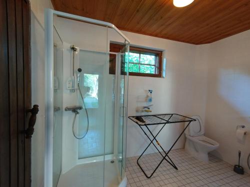 a bathroom with a shower and a toilet at Kuivasjärvi House in Oulu