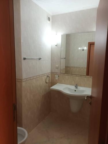 a bathroom with a sink and a toilet at Къща за Гости ,,Afrikana,, in Sveti Vlas