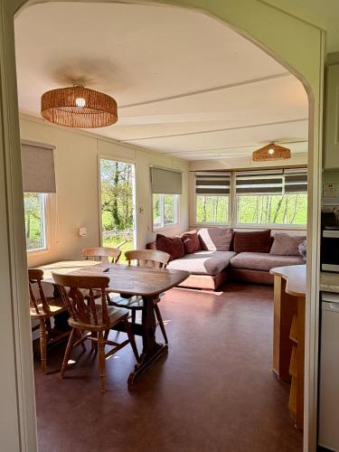 a living room with a table and a couch at Simene cabin in Bridport