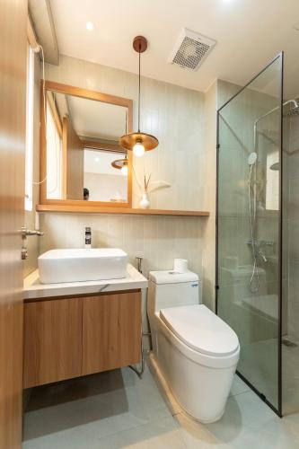 a bathroom with a toilet and a sink and a shower at MIRO Homestay in Hue