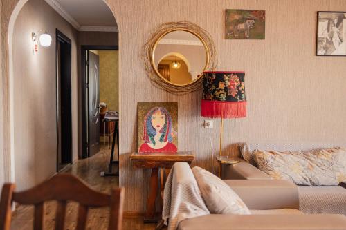 a living room with a couch and a mirror at Bethlehem Terrace in Tbilisi City