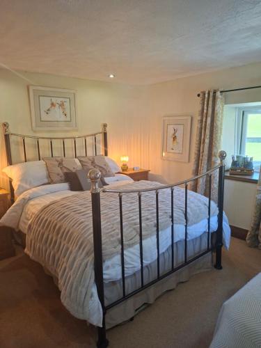 a bedroom with a large bed and a window at Eastview Bed and Breakfast in Garrigill