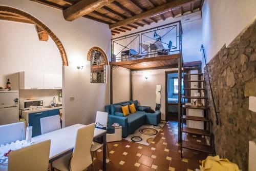 a living room with a blue couch and a kitchen at Spacious 2BR with 2 Ensuite Baths in Florence in Florence
