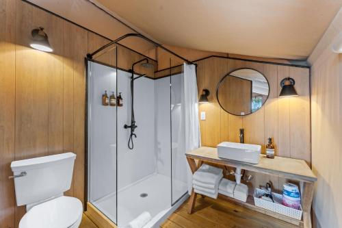 a bathroom with a shower and a toilet and a sink at Glamping Tent, Hike, Smore Vibes in Branson