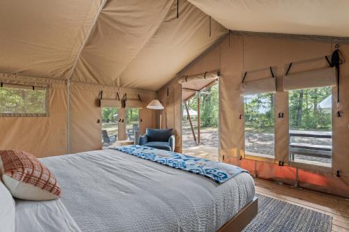 a bedroom with a bed in a tent at Glamping Tent, Hike, Smore Vibes in Branson