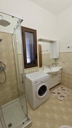 a bathroom with a washing machine and a sink at Holiday in Paradise in Balestrate