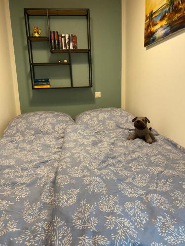 a teddy bear sitting on top of a bed at Haus Ferienglück in Zadelsdorf