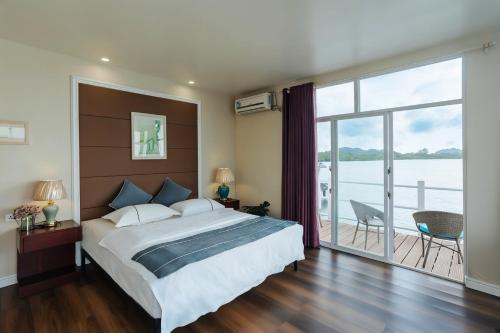 a bedroom with a large bed and a large window at Seaward in Koror